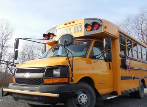 Driver's side corner of yellow bus