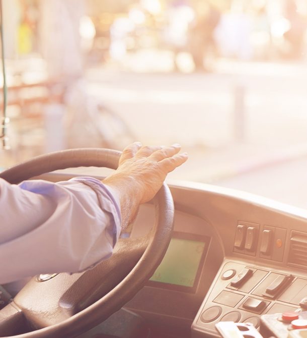 School bus driver turning the wheel of the bus