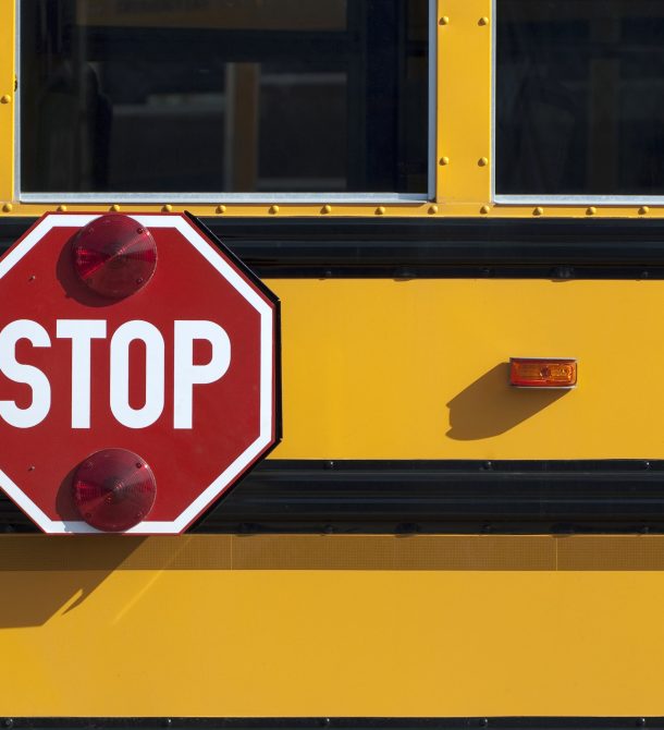 Stop sign on the side of school bus