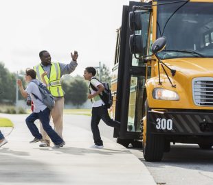 Crossing guard directing kids off the bus