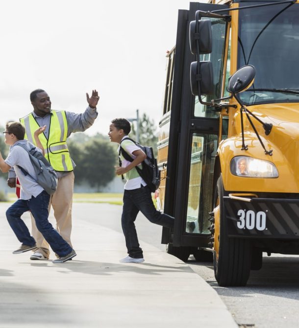 Crossing guard directing kids off the bus