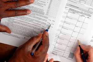 Two people reviewing credit application for bus and van sales