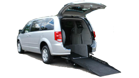 White Gran Caravan with wheelchair accessibility ramp out of the trunk