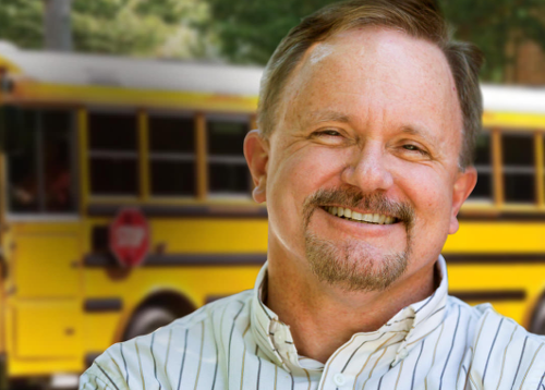 Bermudian Springs School District bus driver posing in front of school bus