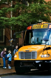 Bus picking up small kids from school