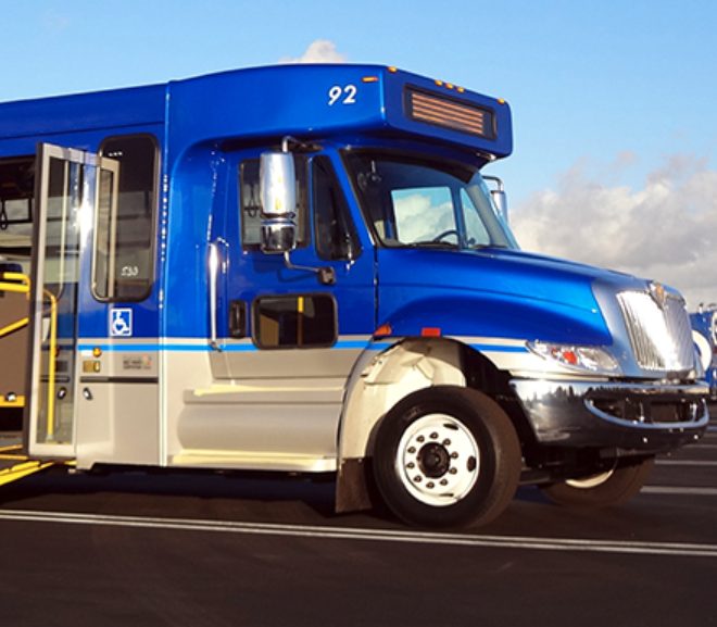 blue passenger bus parked in parking lot