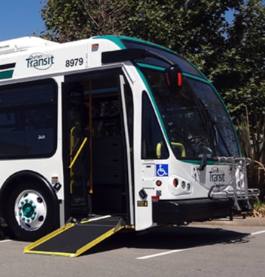 white transit bus with ramp