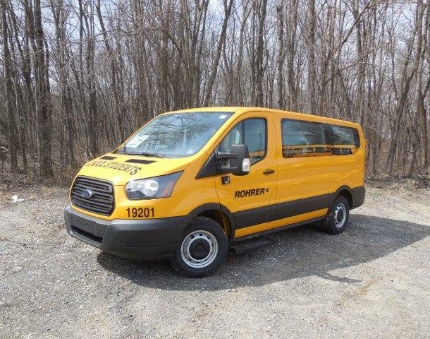 Yellow School Students van parked near trees