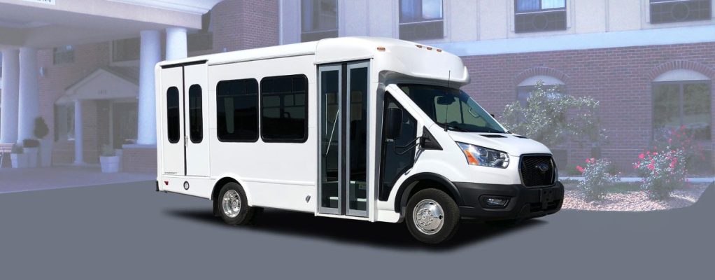 white bus parked in front of hotel