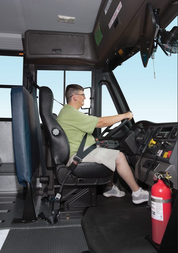 Female school bus driver driving bus